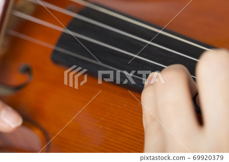A woman playing a violin A woman playing a violin 69920379