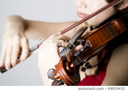 A woman playing a violin A woman playing a violin 69920432
