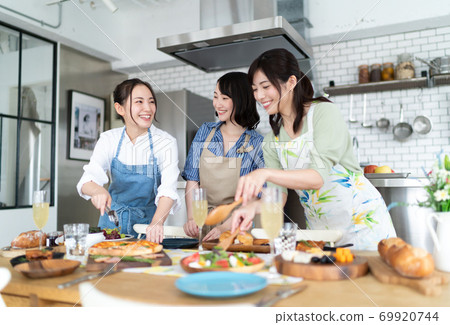 A woman preparing for a home party 69920744