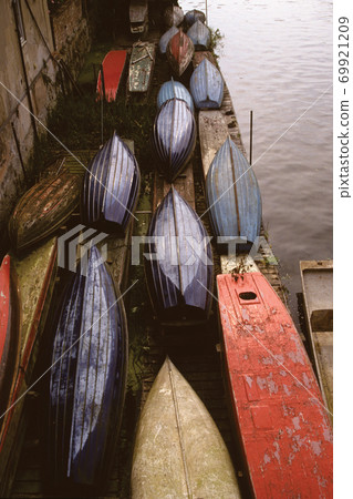 Several colorful ships with their hull upkeep Several colorful ships with their hull upkeep 69921209