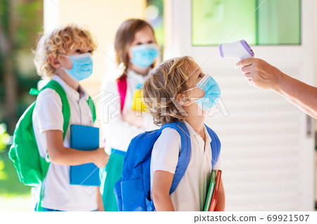 Temperature check at school. Child in mask. 69921507