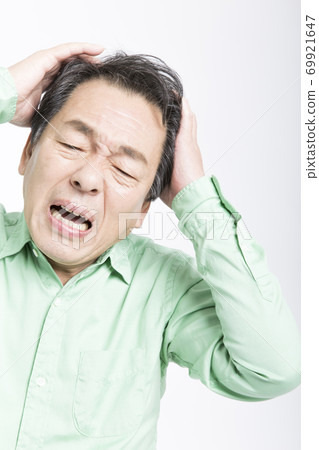 Man holding his head Man holding his head 69921647