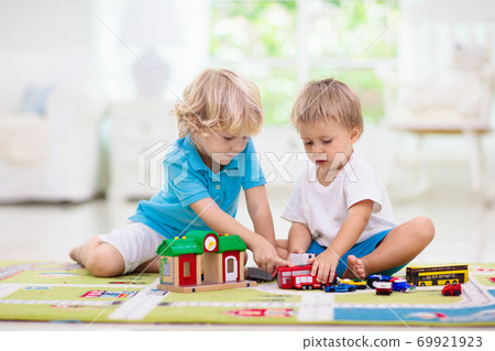 Boy playing toy cars. Kid with toys. Child and car Boy playing toy cars. Kid with toys. Child and car 69921923