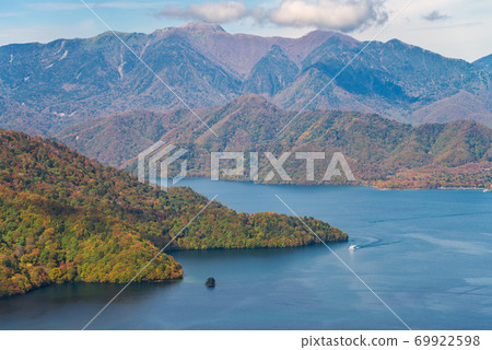 Lake Chuzenji and mountain during autumn season on bright sunny day, Nikko, Japan. 69922598