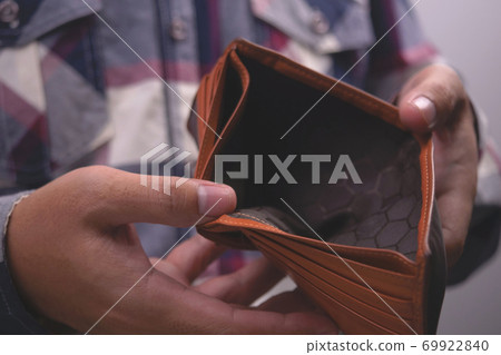 Man showing empty wallet. Poverty finance business bankruptcy and debt concept. 69922840