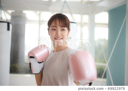 Woman hitting a mitt 69922978