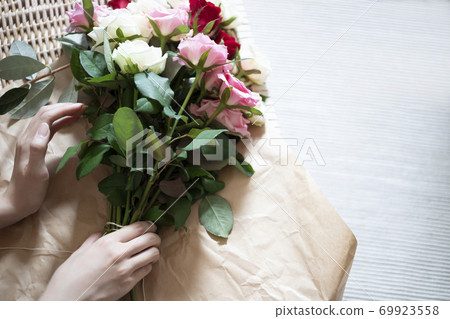 婦女的手裹一束玫瑰 婦女的手裹一束玫瑰 69923558