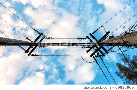 electric pole with wire uprisen angle view and blue sky background electric pole with wire uprisen angle view and blue sky background 69923969