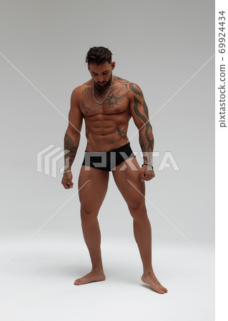 Portrait of muscle man posing in studio Portrait of muscle man posing in studio 69924434