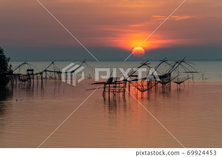 Landmark of giant fishing gears at Pakpra with beautiful sunrise. Landmark of giant fishing gears at Pakpra with beautiful sunrise. 69924453