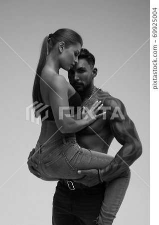 Sexy young couple in studio 69925004
