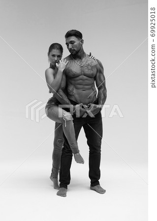 Seductive couple looking at camera Seductive couple looking at camera 69925018
