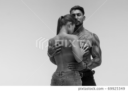 Sexy young couple in studio 69925349