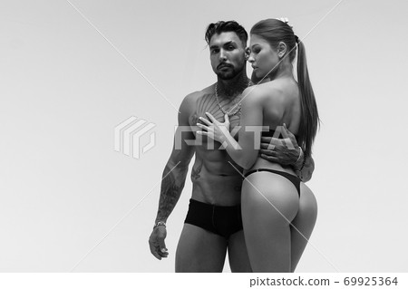 Sexy young couple in studio 69925364