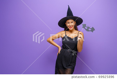 woman in black witch costume 69925896