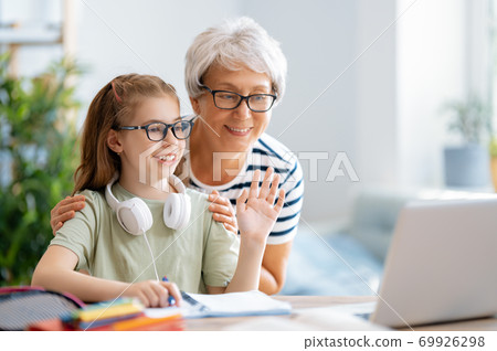 Girl doing homework or online education. 69926298