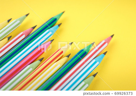 multicolored pencils on yellow isolated background multicolored pencils on yellow isolated background 69926373