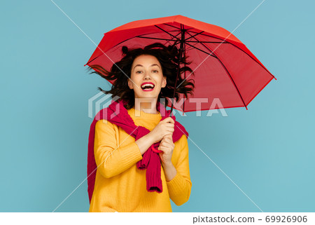 woman with umbrella on color background 69926906