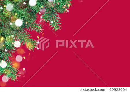 Christmas composition with border of green fir branches on red background 69928004