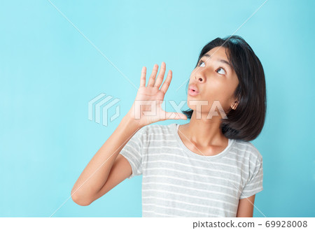 Asian girl expression excited on face on the background blue isolated 69928008