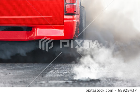 air pollution crisis in city from diesel vehicle exhaust pipe on road 69929437