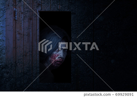 Scary zombie standing behind the door Scary zombie standing behind the door 69929891
