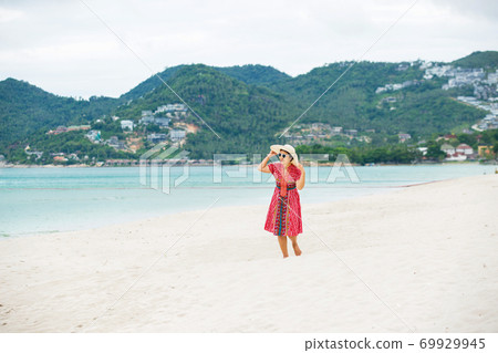 Middle aged woman relaxing at chaweng beach in koh samui ,Thailand. Middle aged woman relaxing at chaweng beach in koh samui ,Thailand. 69929945