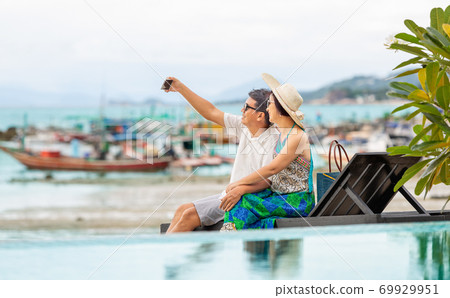 Middle aged couple relaxing at lamai beach in koh samui ,Thailand. Middle aged couple relaxing at lamai beach in koh samui ,Thailand. 69929951