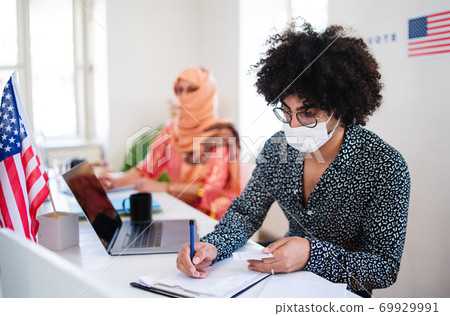 Members of electoral commission in polling place, usa elections and coronavirus. Members of electoral commission in polling place, usa elections and coronavirus. 69929991