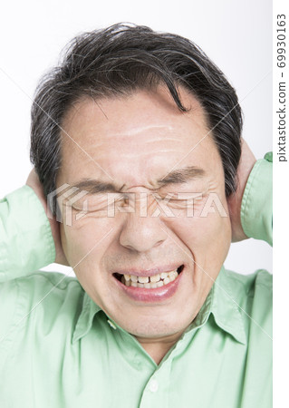 Man holding his head Man holding his head 69930163