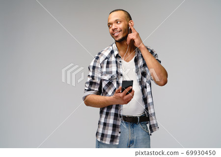 studio shot young african american man listening to music with earphones 69930450