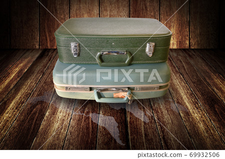 Vintage travel bag on wooden floor Vintage travel bag on wooden floor 69932506