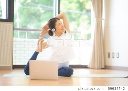 Women doing online yoga Women doing online yoga 69932542