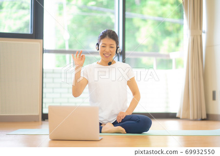 Women doing online yoga Women doing online yoga 69932550