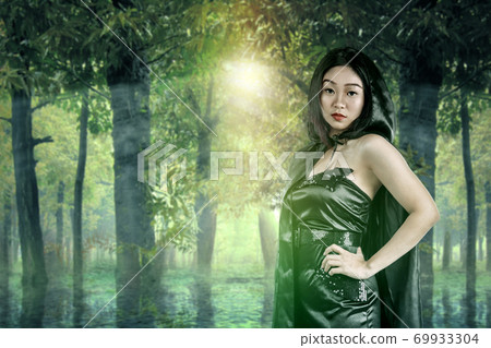 Asian witch woman with a cloak standing Asian witch woman with a cloak standing 69933304