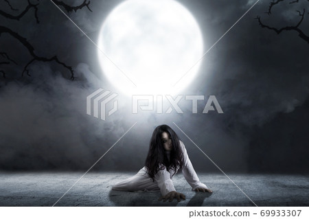 Scary ghost woman crawling with night scene background 69933307