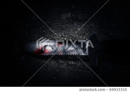 Bloody knife with zombie shadow on the blade with a grunge wall background Bloody knife with zombie shadow on the blade with a grunge wall background 69933310