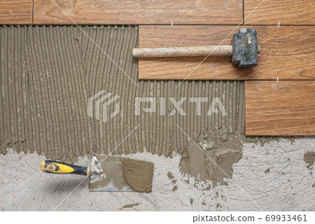 Worker placing ceramic. Worker placing ceramic. 69933461