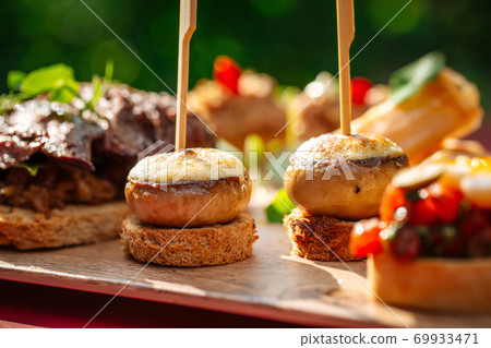 Assorted spanish tapas with different toppings Assorted spanish tapas with different toppings 69933471