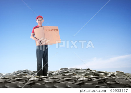Asian man carrying box with donation text to collecting donations  69933557