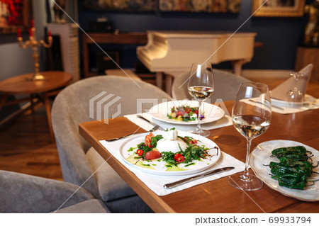 Restaurant table served with spanish salads Restaurant table served with spanish salads 69933794