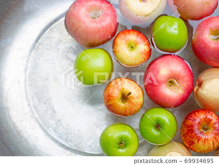 Washing fresh apples in the water Washing fresh apples in the water 69934695