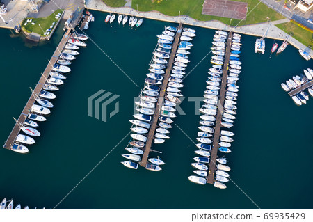 Boats moored at dock in Lovere port Boats moored at dock in Lovere port 69935429