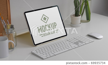 Worktable with mock up tablet, keyboard, mouse, stationery and plant vase on white table 69935734