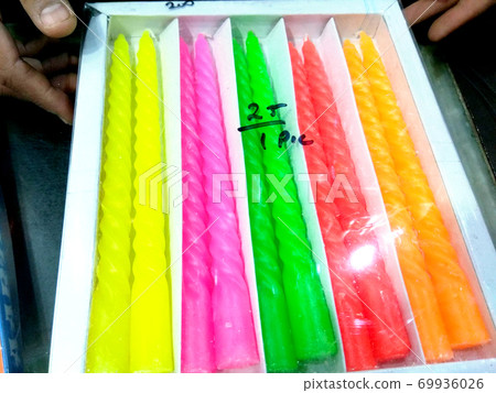 Plastic pack of colorful candles on a shop of india Plastic pack of colorful candles on a shop of india 69936026