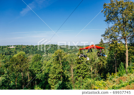 Zipline adventure activity for Cablecar Sigulda to Cablecar Krimulda with green forest mountain in Sigulda, Latvia 69937745