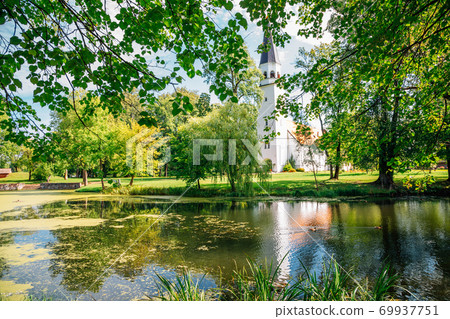 Sigulda Evangelic Lutheran Church with pond and forest in Sigulda, Latvia 69937751