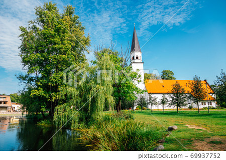Sigulda Evangelic Lutheran Church with green trees in Sigulda, Latvia 69937752