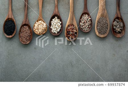 Different types of grains and cereals on shabby concrete background. 69937874