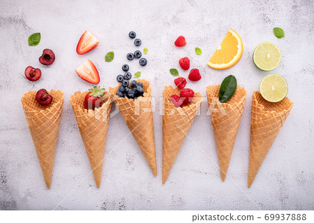 Various of fruits  in cones blueberry ,strawberry ,raspberries and strawberry setup on white stone background . Summer and Sweet menu concept. 69937888
